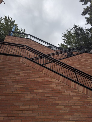 Photo of a series of tall brick stairs.